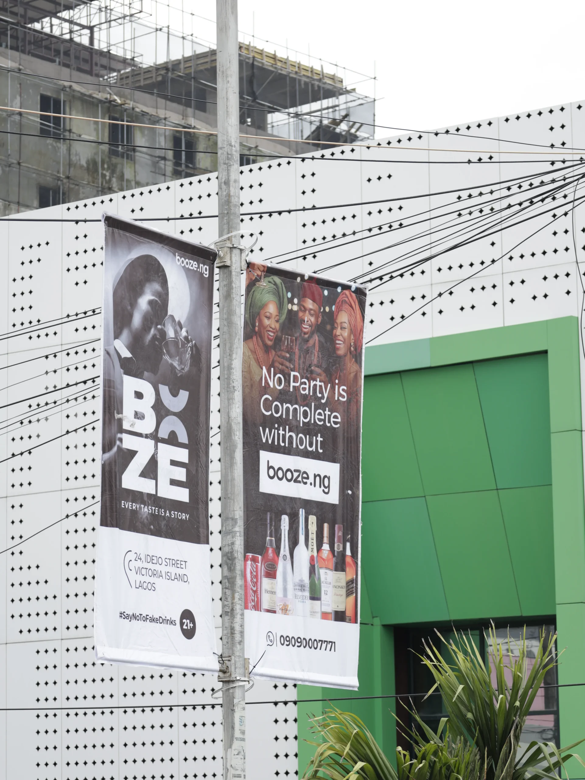 Booze.ng billboard campaign creative displayed along a busy commercial road in Lagos
